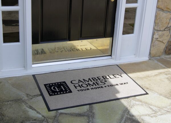 Flocked Camelot in Use - Showcase of the custom logo mat in action, enhancing entrances with a stylish and durable design