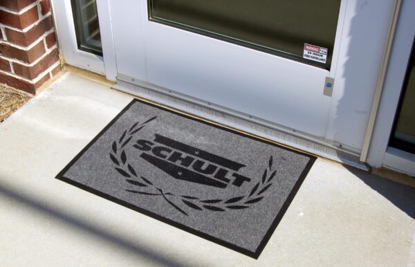 Screen Print Camelot in Use - Illustration of the versatile low-profile entrance mat in action, suitable for various settings, including giveaway programs, apartment complexes, and banks